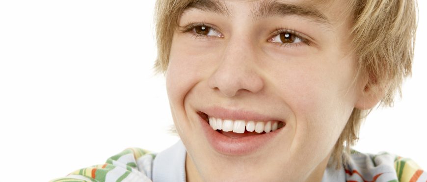 Studio Portrait Of Smiling Teenage Boy